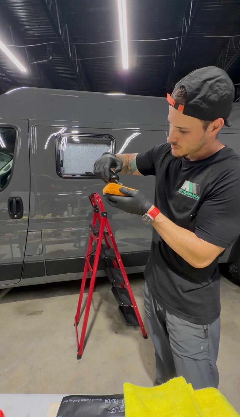 Minty detailer carefully preparing a coating applicator